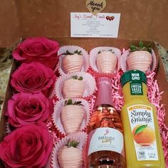 a box filled with lots of different types of drinks and flowers next to each other