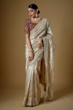 Champagne gold tulle and handloom tissue silk saree with pearls, cutdana and glass beaded hand embroidery. Comes with a chillie red padded blouse and an underskirt. - Aza Fashions Tussar Silk Blouse Piece With Sheer Dupatta For Reception, Raw Silk Saree With Gota Work For Reception, Reception Raw Silk Saree With Gota Work, Elegant Pre-draped Saree In Tissue Silk With Gota Work, Elegant Tissue Silk Pre-draped Saree With Gota Work, Wedding Tussar Silk Blouse Piece With Gota Work, Elegant Tussar Silk Pre-draped Saree With Gota Work, Elegant Pre-draped Tussar Silk Saree With Gota Work, Elegant Pre-draped Tissue Silk Saree With Gota Work