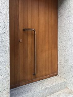 an open door with a handle on the side of it and steps leading up to it