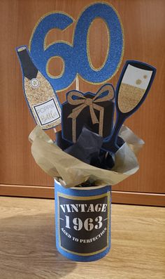 an old - fashioned birthday card in a can is decorated with wine and chocolates