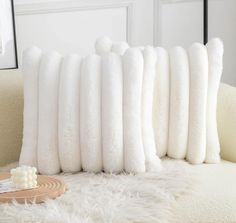 a bunch of pillows that are sitting on a couch