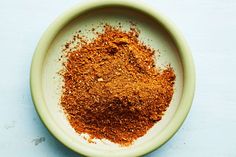 a bowl filled with spices on top of a table