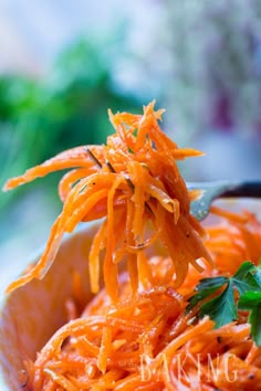 a spoon full of shredded carrots with parsley