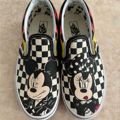 Disney And Vans Partnered To Celebrate Mickey Mouse’s 90th Anniversary. Disney X Vans Slip-On 'Mickey & Minnie' Features A Canvas Upper Dressed In A Black And White Checkerboard Color Scheme. The Low Top Also Boasts Flame Designs On The Side Panel, A Padded Collar For Comfort, A Large Mickey Mouse Or Minnie Mouse Head Printed On Each Toe Box, And A Vulcanized Outsole For Flexibility And Superior Traction. Classic Slip-On New! Never Worn No Box Black Mickey Mouse Sneakers For Streetwear, Casual Black Mickey Mouse Sneakers, Casual Black Sneakers With Character Print, Mickey Mouse Themed Fun Round Toe Sneakers, Casual Minnie Mouse Sneakers With Round Toe, Black Sneakers With Character Print, Minnie Mouse Head, Flame Design, Vans Slip On