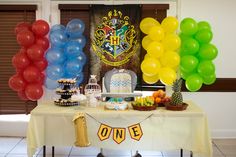 a table topped with balloons and cake