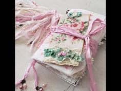 an old book covered in pink ribbon and lace