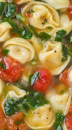 a bowl filled with pasta and spinach soup