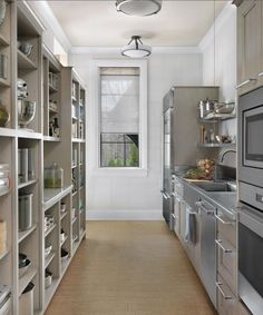 an empty kitchen with stainless steel appliances and shelves full of dishes on the counter top