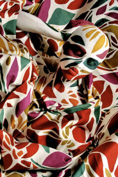 the fabric is very colorful and has an interesting pattern on it's surface,