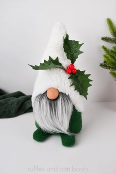 a green and white stuffed toy with holly on it's head