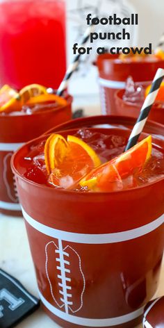 football punch for a crowd is garnished with oranges and striped straws