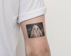 a person with a ghost tattoo on their arm