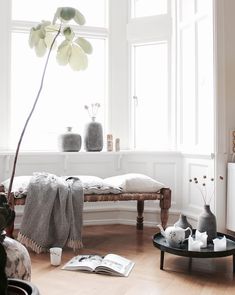 a living room filled with furniture and a large window