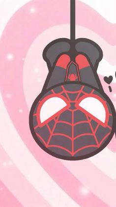 a spider - man hanging from a string with hearts in the background