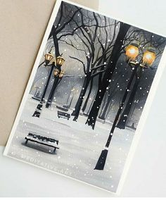 there is a card with an image of a park bench and street lights in the snow