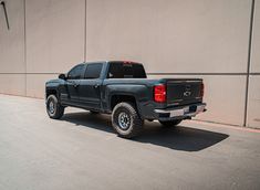 a black truck parked in front of a building