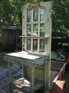 an old window is sitting in the back of a truck