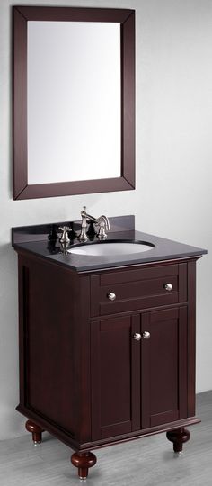 a bathroom vanity with a mirror above it