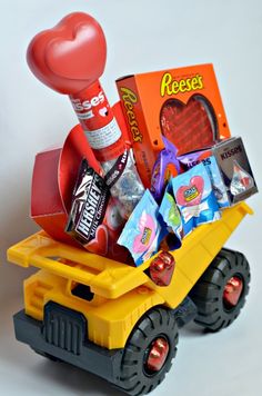 a toy dump truck filled with candy and candies in the shape of a heart