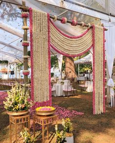 an outdoor wedding setup with flowers and greenery