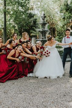 a bride and groom posing with their bridal party