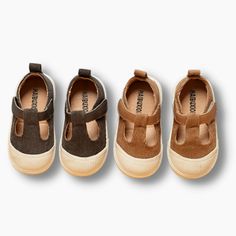 three pairs of brown shoes with straps on them, one in the middle and one in the