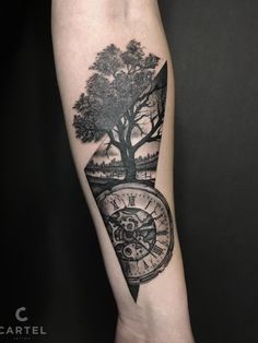 an arm with a clock and tree on it