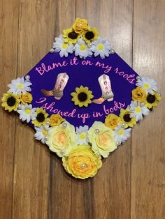 a purple graduation cap with flowers on it