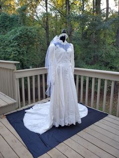 a wedding dress on display on a deck