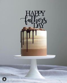 a cake that is sitting on top of a white plate with the words happy father's day written on it