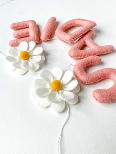 the letters are made out of felt and flowers