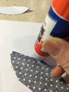 someone is making a paper christmas tree out of construction paper and glue on the fabric