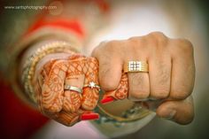 two people holding hands with rings on their fingers