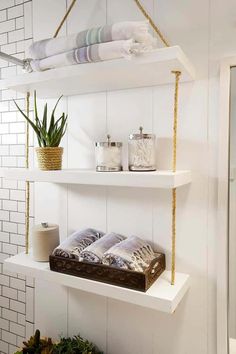 bathroom shelves with towels and plants on them