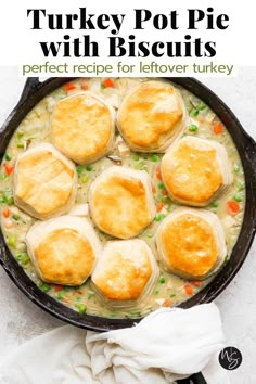 turkey pot pie with biscuits in a cast iron skillet on a white background