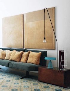 a living room filled with furniture and a painting on the wall