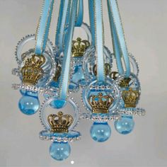 a chandelier with blue and gold decorations hanging from it's sides