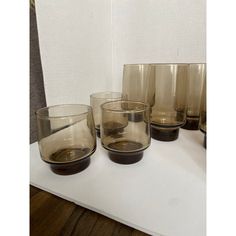 several glasses are lined up on a table