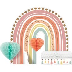 an assortment of decorative items including tissue lanterns, paper hearts and rainbows on a white background