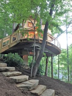 a tree house with stairs leading up to it