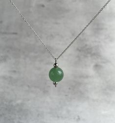 "Green jade pendant necklace for women. Explore ways to layer this piece or wear it on its own for a minimal look. Dainty, minimal, hypoalergenic, lightweight,  stylish necklace. Great gift idea for women (wife, girlfriend, mom, sister...). Necklace length: 36 cm (14\") + 5cm (2\") chain extension.  Please email me for a longer or shorter size of the necklace. Green jade bead - 10 mm. GREEN JADE (NEPHRITE): * is the stone of spiritual wealth and physical vitality * it is best known for it's posi Elegant Jade Necklace With Adjustable Chain, Jade Clavicle Chain Necklace, Minimalist Round Bead Charm Necklace As Gift, Green Minimalist Everyday Necklace, Minimalist Crystal Necklace With Delicate Chain, Green Minimalist Necklace For Everyday, Minimalist Crystal Pendant Necklace With Delicate Chain, Minimalist Crystal Pendant Necklace For Meditation, Minimalist Pendant Charm Necklaces For Meditation