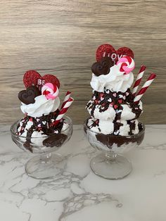 two glasses filled with ice cream and mickey mouse toppings on top of each other