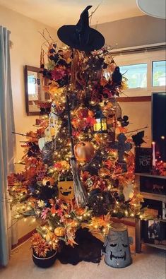 a decorated christmas tree with pumpkins and witches