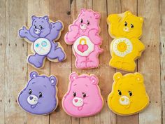 teddy bear cookies are arranged on a wooden table