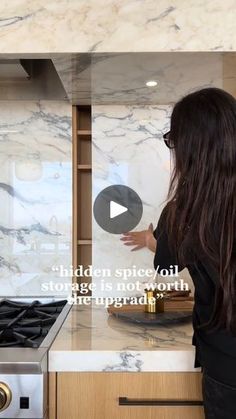 a woman standing in front of a stove top oven