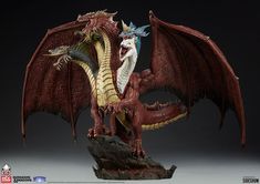 a red and white dragon statue sitting on top of a piece of driftwood in front of a black background