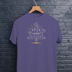 a purple t - shirt hanging on a brick wall