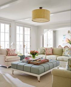 a living room filled with lots of furniture and decor on top of carpeted flooring