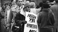 black and white photograph of people holding protest signs