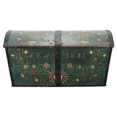 an old trunk with flowers painted on it